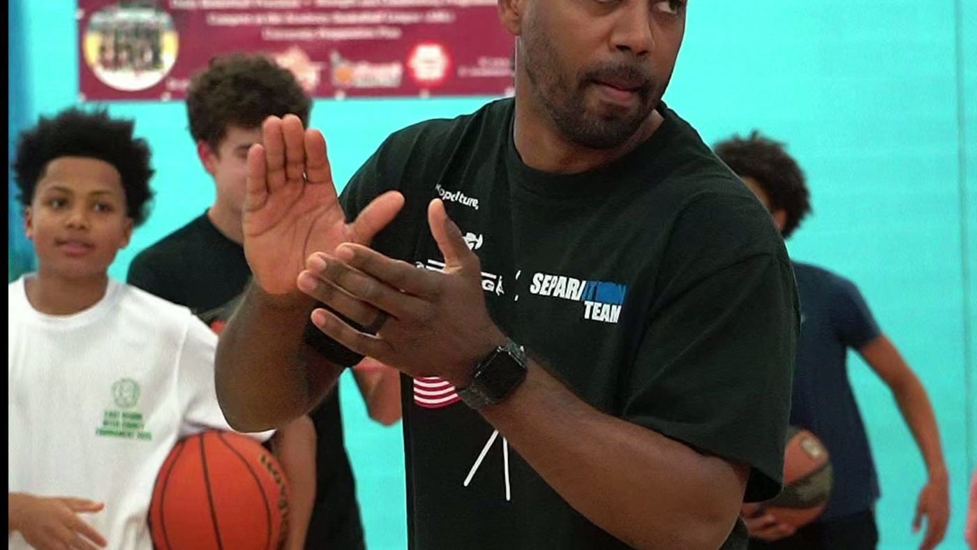 Coach celebrating with a young player